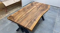 a wooden table sitting on top of a tiled floor