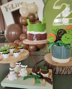 an assortment of cakes and cupcakes are on display