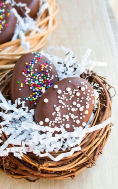 chocolate covered donuts in a nest with sprinkles