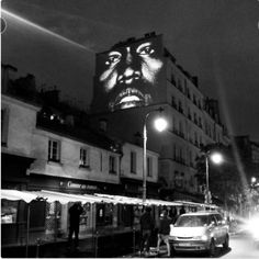 a black and white photo of a man's face on the side of a building