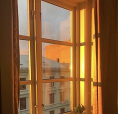 a bathroom window with the sun shining through it's glass panes and windowsills