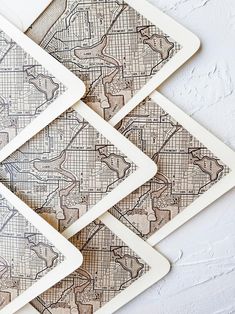 four coasters that have been designed to look like maps