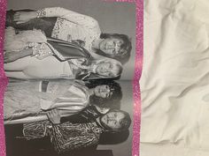 an old black and white photo of three women posing for the camera in front of a pink background