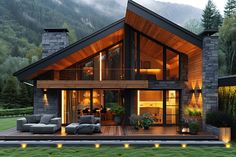 a modern house in the middle of a lush green field with mountains in the background