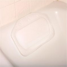 a close up of a bath tub with a white toilet seat cover on the side