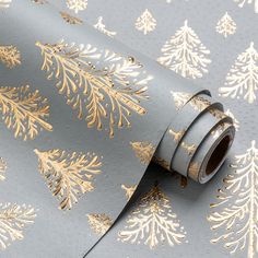 a grey and gold christmas tree wallpaper with golden pine trees on the back ground