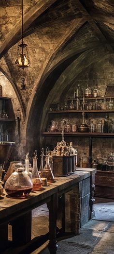 an old fashioned kitchen with many pots and pans on the table in front of it