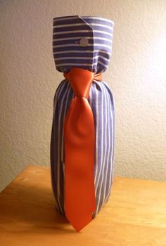 a blue and white striped bag with an orange tie tied around the neck on a wooden table