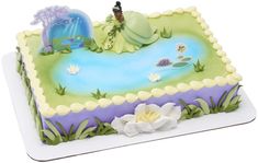 there is a cake that looks like the little mermaid on the lake with flowers around it