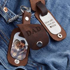 a leather keychain with a photo on it and a tag that says dad