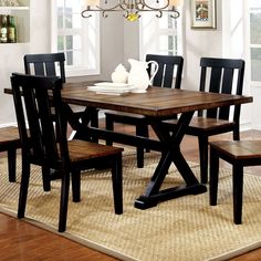 a dining room table with chairs and a chandelier