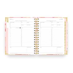 an open planner book with pink and gold trimmings on the front, featuring two pages