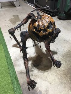 a statue of a spider crawling on the ground