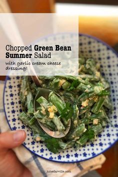 a blue and white plate topped with green bean salad