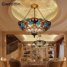 a dining room table with chairs and a chandelier hanging from it's ceiling