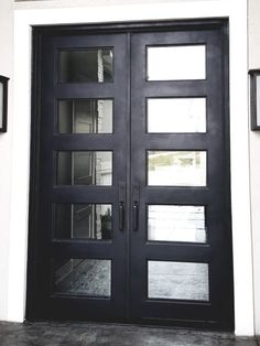 a black double door with glass panels on the outside