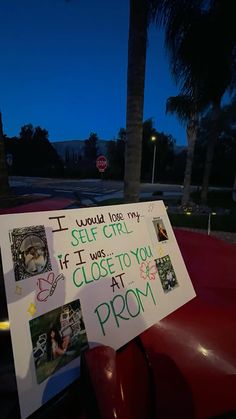 a sign posted on the back of a red car that says i would love my self girl if it was close to you at prom