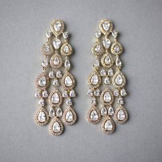 Created with pave set pear cut CZ jewels and tiny pear stones, this layered look wedding earring style is sure to turn heads. They are dainty but have luxury styling. These post-back pierced earrings are rhodium or gold plated, measure 2.5 inches long and .75 an inch wide, grade AAA CZ, and are lead and nickel free. Teardrop Chandelier Earrings With Diamond Accents, Elegant Teardrop Chandelier Earrings In Cubic Zirconia, Cubic Zirconia Teardrop Chandelier Earrings, Elegant Cubic Zirconia Teardrop Chandelier Earrings, Glamorous Drop Chandelier Earrings For Anniversary, Teardrop Cubic Zirconia Chandelier Earrings, Teardrop Chandelier Earrings With Sparkling Stones For Anniversary, Elegant Teardrop Chandelier Earrings For Anniversary, Gold Teardrop Chandelier Earrings With Diamond Accents