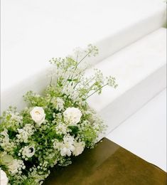 a bouquet of white flowers sitting on top of a table