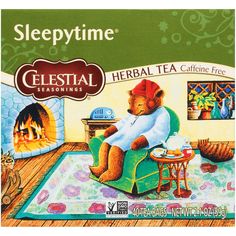 a box of celestial tea with a teddy bear sitting on a chair in front of a fireplace