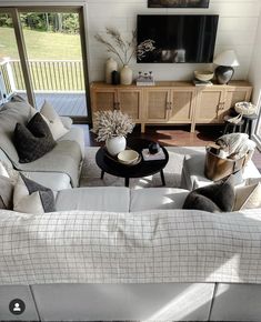 a living room filled with furniture and a flat screen tv on top of a wall