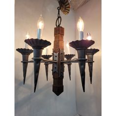 a chandelier with five candles hanging from it