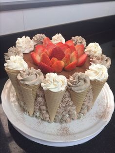 a chocolate cake topped with strawberries and whipped cream