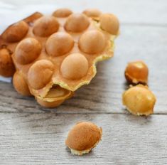 some food that is on top of a wooden table and has holes in the middle