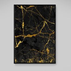 a black and gold marble wall hanging on a gray wall