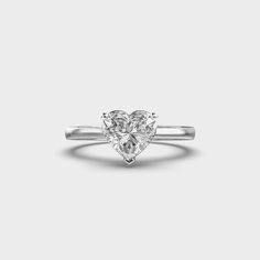 a heart shaped diamond ring on a white background