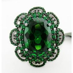 Karat : .925 Sterling Silver Gemstones : 1 Lab Created Emerald - 7.85 Carats Emerald Grades, Hue . . . Green Tone . . . Medium Dark Saturation . . . Excellent No Inclusions Or Flaws 124 Genuine Peridots - 0.01 Ct Each Total Ct Weight : 1.24 Carats Peridot Grades, Hue . . . Green Olive Tone . . . Medium Saturation . . . Strong No Inclusions Or Flaws Shape Of Stone : Oval & Round Setting : Prong Size : 8.25 Net Weight : 7.4 Grams Dimensions : 14 Mm X 10 Mm - Main Gemstone Measurements Green Sterling Silver Jewelry With Center Stone, Green Sterling Silver Jewelry With Halo Setting, Vintage Green Jewelry With Halo Setting, Green Sterling Silver Gemstones For Formal Occasions, Green Jewelry With Accent Stones For Collectors, Collectible Green Jewelry With Accent Stones, Green Collectible Jewelry With Accent Stones, Collectible Hallmarked Green Jewelry, Collectible Green Emerald Ring With Center Stone