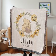 a baby blanket with a teddy bear holding a basket