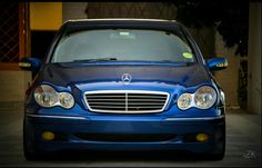 a blue car parked in front of a building