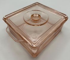 an empty glass dish with a gold lid