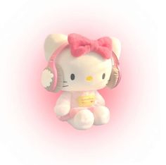 a hello kitty stuffed animal with headphones on it's ears, sitting in front of a pink background