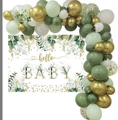 an image of a baby shower decoration with balloons and greenery in gold, green and white colors