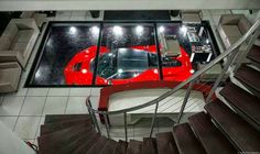 an overhead view of a car parked in a garage with stairs leading up to it