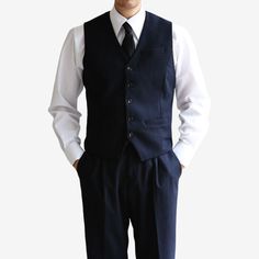 Introducing the Classic Fit Men's Basic Wool Blend Suit Vest in Navy Color. This dress suit waistcoat is a stylish addition to elevate any gentleman's formal attire. Designed with a classic fit, this vest offers a timeless and sophisticated silhouette. The navy color adds a touch of refinement, making it suitable for a variety of formal occasions and events. The 5-button design of this waistcoat adds a polished and traditional touch. It features a clean and minimalistic design, allowing it to effortlessly complement any dress shirt and suit combination. Whether you're attending a wedding, a business meeting, or any formal event, the Classic Fit Men's Basic Wool Blend Suit Vest in Navy Color is the perfect choice to complete your formal ensemble. It exudes sophistication and adds a refined Professional Single Breasted Three-piece Suit For Semi-formal Occasions, Single Breasted Three-piece Suit For Business Casual, Single-breasted Three-piece Suit For Business Casual, Professional Single Breasted Three-piece Suit, Professional Three-piece Single-breasted Suit, Notch Lapel Business Casual Vest With Pockets, Notch Lapel Vest With Pockets For Business Casual, Business Casual Notch Lapel Vest With Pockets, Sleeveless Business Outerwear With Button Closure