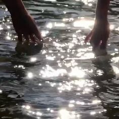 two people are standing in the water with their feet above the water's surface