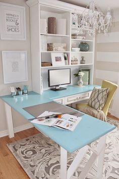 a desk with a computer on it in front of a book shelf and bookshelf