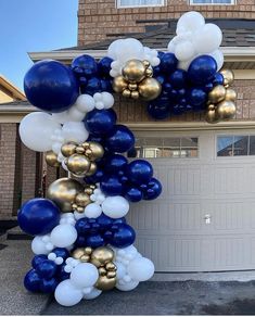 blue and gold balloon arch in front of a house