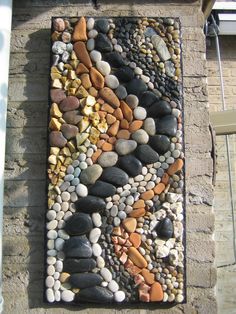 a stone wall with various colored rocks on it