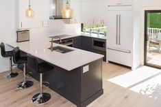 a kitchen with an island and two stools