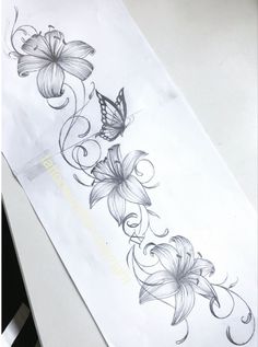 a drawing of flowers and a butterfly on a white paper with watermarked writing