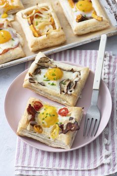 two pieces of pizza on a plate with a fork