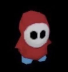 an odd looking object with two eyes and a red scarf on it's head