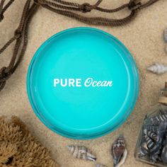 a blue frisbee sitting on top of a sandy beach next to other items