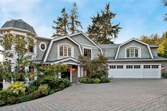 a large house with lots of windows and landscaping