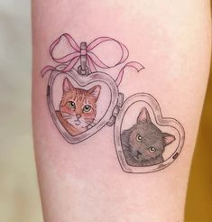 a cat and a heart shaped locke tattoo on the right thigh with a bow around it