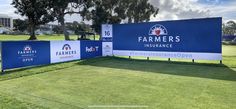 the farmers insurance sign in front of an open field